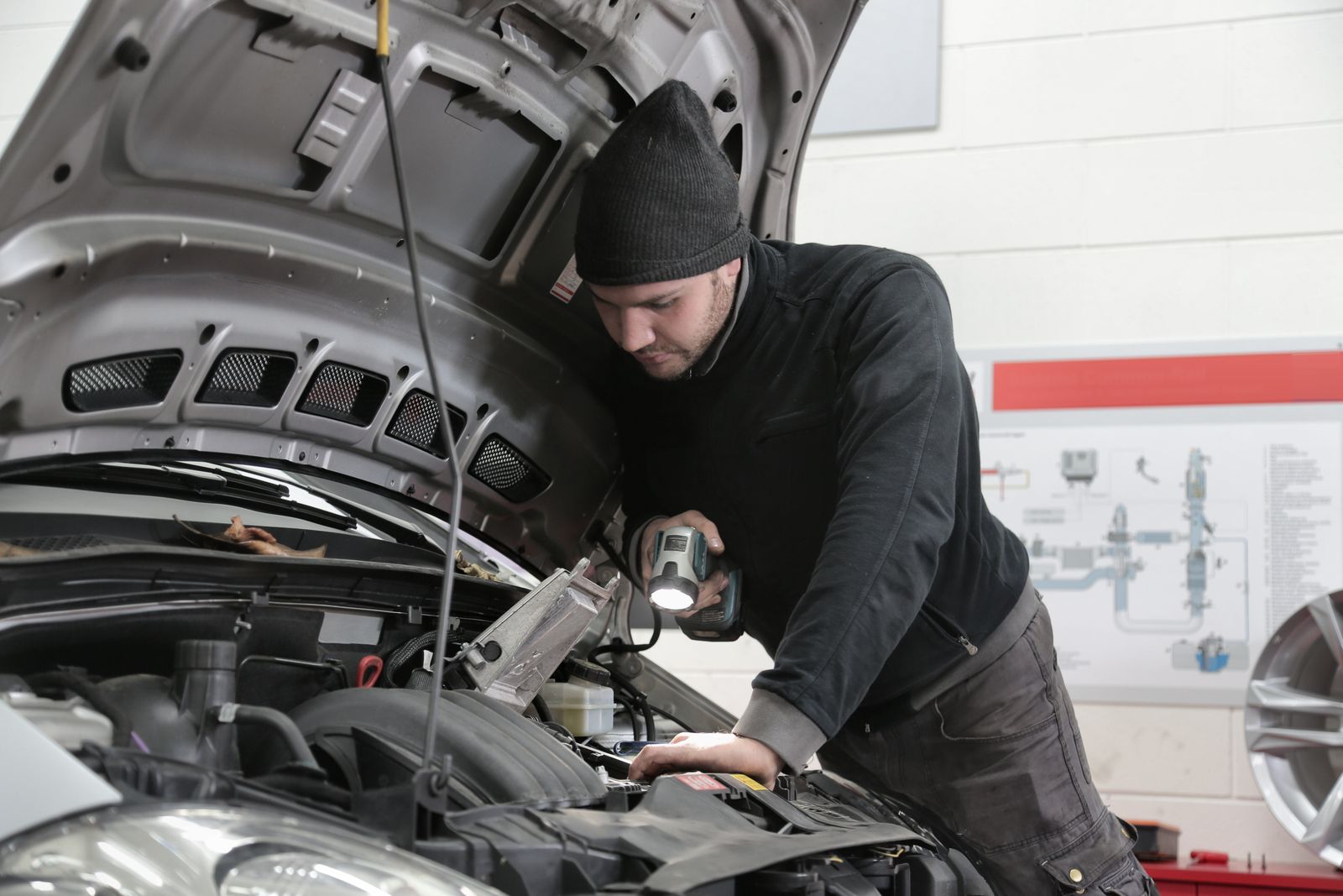 Certified mechanic inspecting a vehicle engine